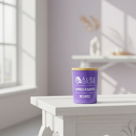 Be Lovely Aloe Colors scented soy candle with caramel and bitter almond in a purple container